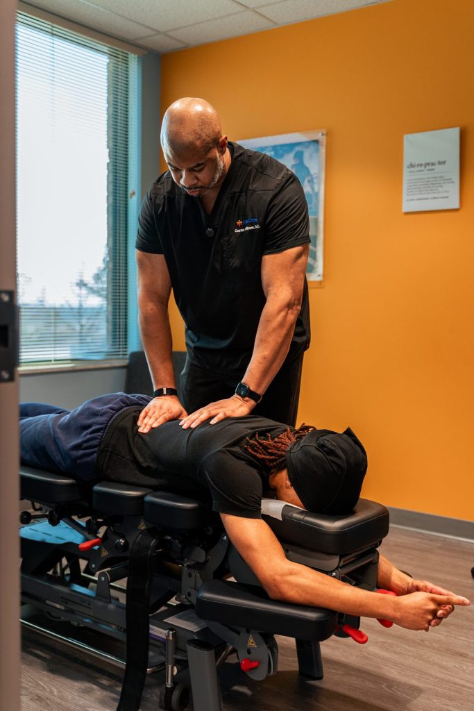 "Dr. Williams performing a spinal adjustment on a patient in the CJW Chiropractic Solutions treatment room"