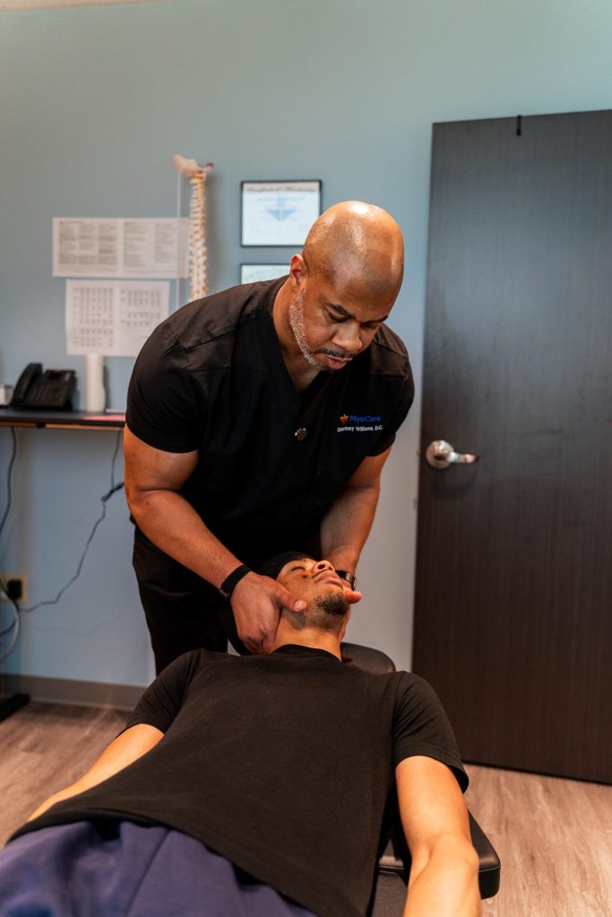 "Cervical spine adjustment being performed for headache and neck pain relief"