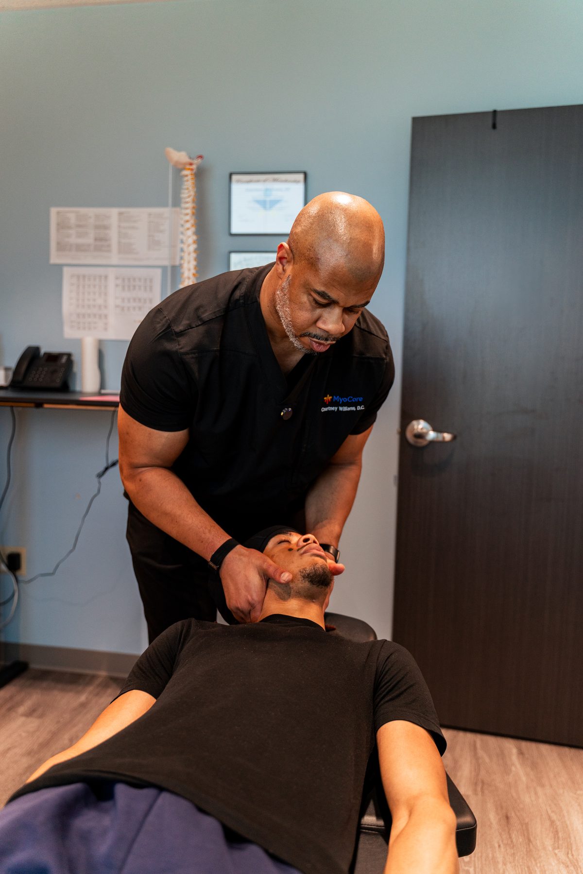 "Cervical spine adjustment being performed for headache and neck pain relief"