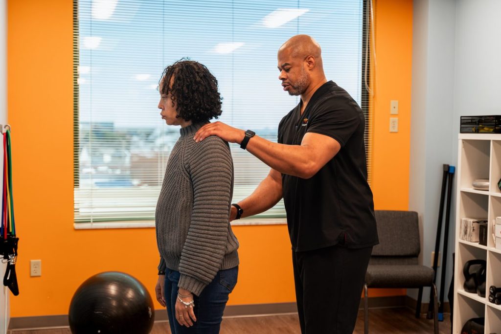 "Doctor consulting with a patient at CJW Chiropractic Solutions"