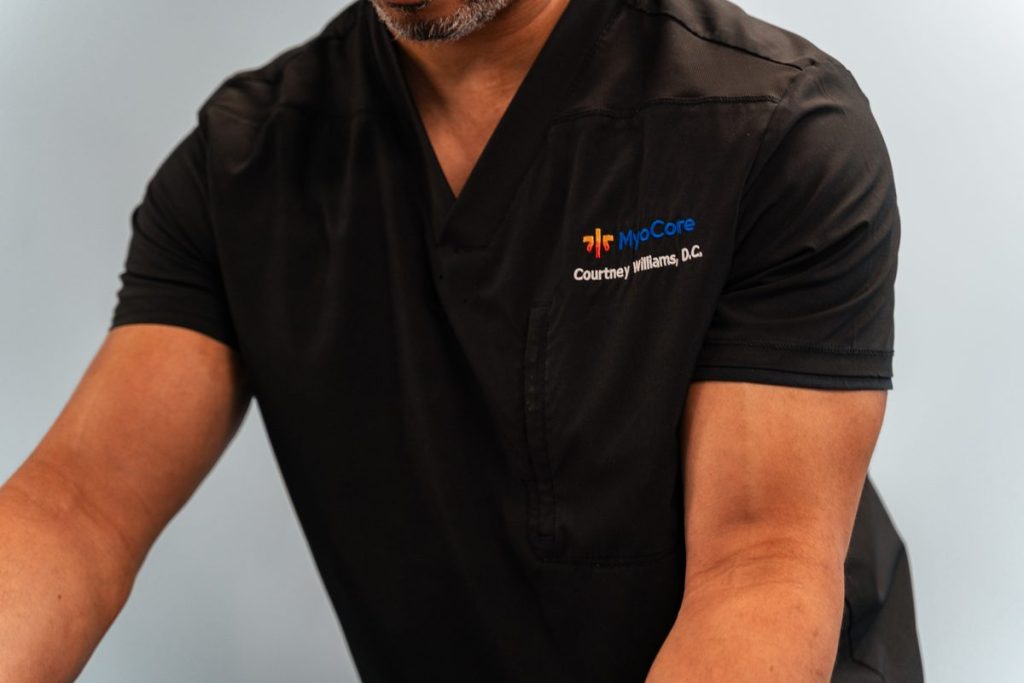 "Dr. Williams demonstrating a hands-on technique with a patient"