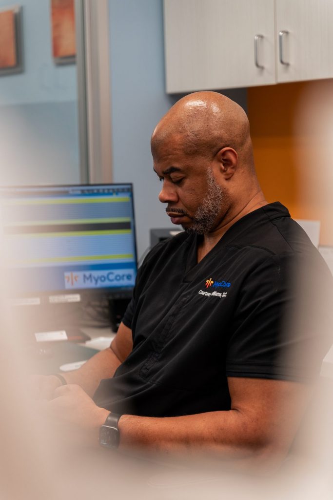 "Dr. Wilson assessing a patient's posture during evaluation"